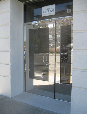 Mirror finish stainless steel entry to retail or restaurant space that is for lease in the Press Building, Martinez, CA.