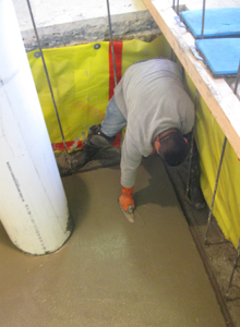 Finishing touches are added to the newly poured concrete floor.