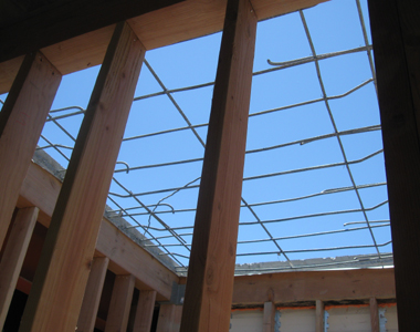 Sky is seen through the rebar where the concrete roof has been removed.
