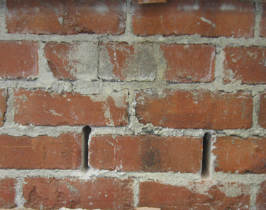 Mortar joints removed at each end of a brick before testing.