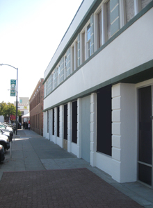 Streamline Moderne building with completed paint along the Court Street façade.