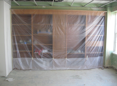 Plastic covering bookcases prior to spraying texture.