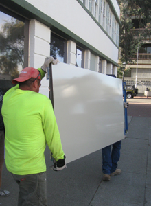 Elevator doors are delivered after being painted off site.