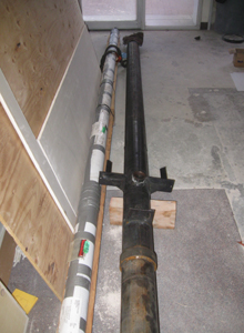 The elevator piston (in a shipping tube) and its cylinder lie side by side.