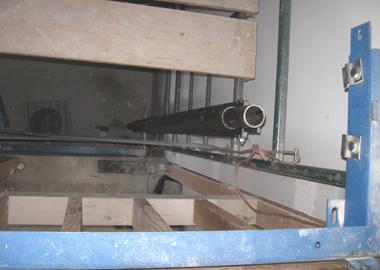 Segments of side rails being stacked up towards the blue bracket on the second story.