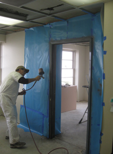 A door frame is painted as a part of the re-finishing process.
