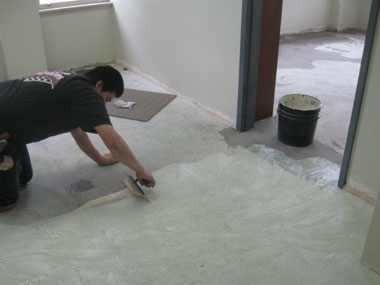 Carpet adhesive is spread in one of the upstairs suites.