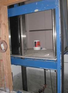 The elevator rises above the first floor.