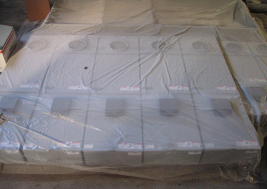 Electric panels under a plastic painter’s tarp.