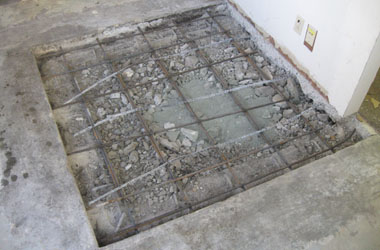 After removing an old patch, rebar is dowelled into the adjacent slab to prevent the new patch from raising up.