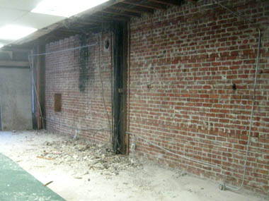 Demolition to expose brick wall.