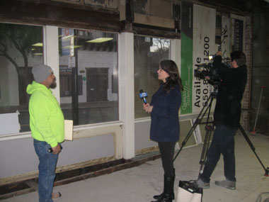 ABC Channel 7 News reporter Elissa Harrington interviews Southport Land employee.