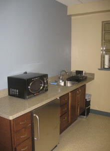 Appliances and other furnishings finish the break room in the upstairs common area.