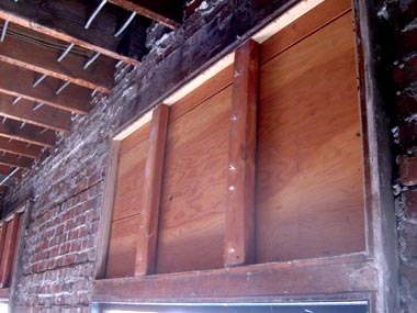 Plywood discovered where a transom window once was.