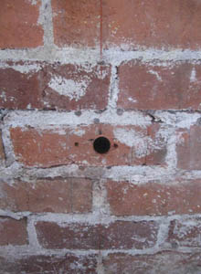 Hole drilled into bricks at 22-1/2 degree angle.